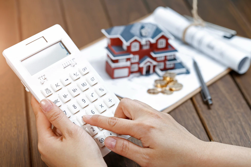 female-hand-operating-calculator-front-villa-house-model-1387-956.webp